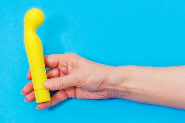 Mujer Sosteniendo Vibrador Amarillo Sobre Azul —  Fotos de Stock