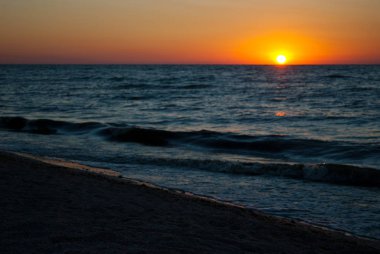 Deniz, turuncu kırmızı güneş, mavi ve pembe mor gökyüzü bulutlar, mavi deniz, kum dalga tatil olmadan güzel gündoğumu