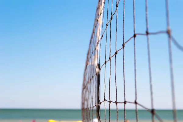 net for playing volleyball closeup connected rope rope on blue sea blue beach summer day leisure sports game