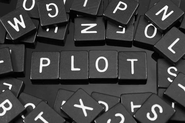 Black letter tiles spelling the word "plot" — Stock Photo, Image