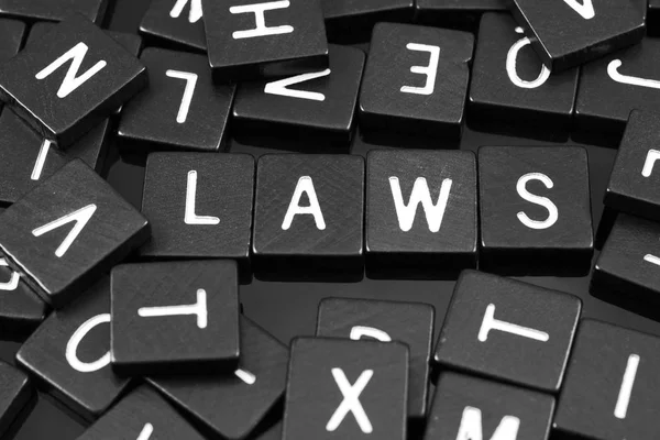 Schwarze Buchstaben Kacheln buchstabieren das Wort "Gesetze" — Stockfoto