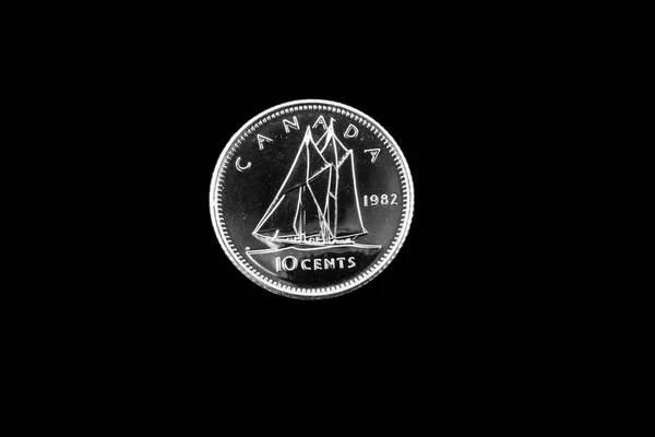 Old Canadian dime on a black background Stock Image