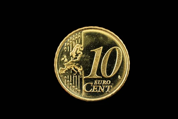 A ten euro cent coin on black