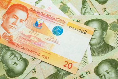 Filipinler 'den gelen portakal rengi bir banknot. İçinde Çin malı bir yuan banknot var. Makroda kapanıyor.