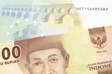 Turuncu bir 5 bin Endonezya rupia banknotu ve 5 avro. 