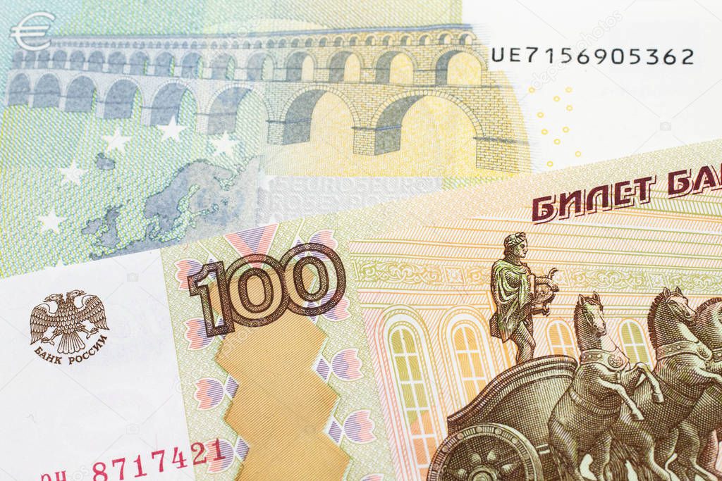 A close up image of a one hundred Russian ruble bank note close up with a five Euro bank note