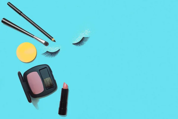 Makeup products on blue background, flat lay — Stock Photo, Image