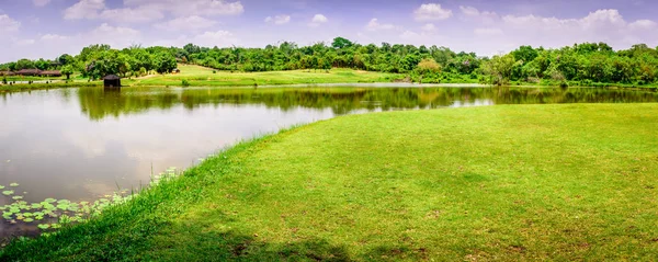 landscape photo of beautiful scenery with lake, grass field and hill, near Yangon, Myanmar
