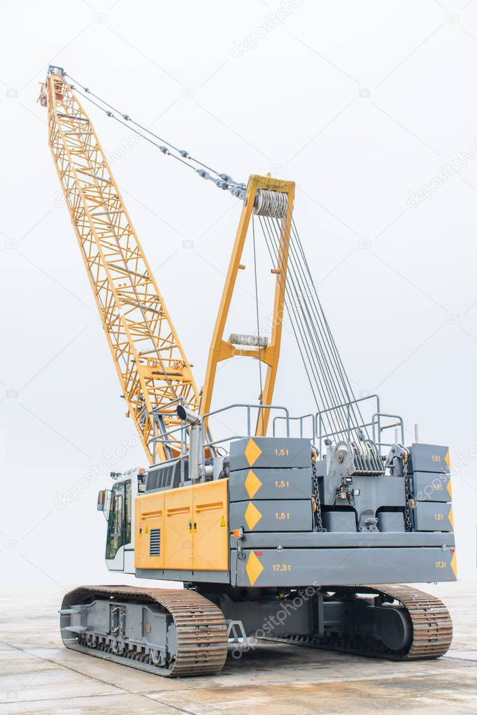 photo of huge crawler crane with isolated background