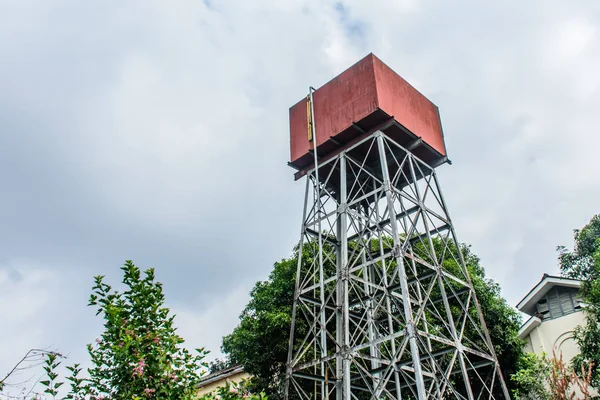 Photo of water tower with cloudy sky — Stock Photo, Image