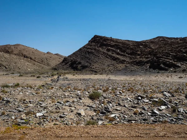 Rock dağ kuraklık manzara zemin taş yarma ile benzersiz coğrafyasının Namib Çölü kaba, yeşil bitki çöl ve mavi gökyüzü arka plan net