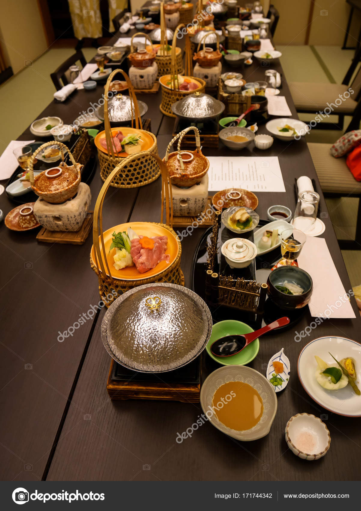Japanese ryokan kaiseki dinner sets serve in family private room including  appetizer such as cherry blossom tofu, pork shabu hot pot and basket,  sashimi, fried and warm dishes and plum liquor Stock