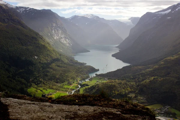 Scenic view of valley and Lovatnet from a mountaintop near via ferrata at Loen,Norway with mountains in the background.heavy cloud cover in october morning,norwegian outdoor beauty — Stock Photo, Image
