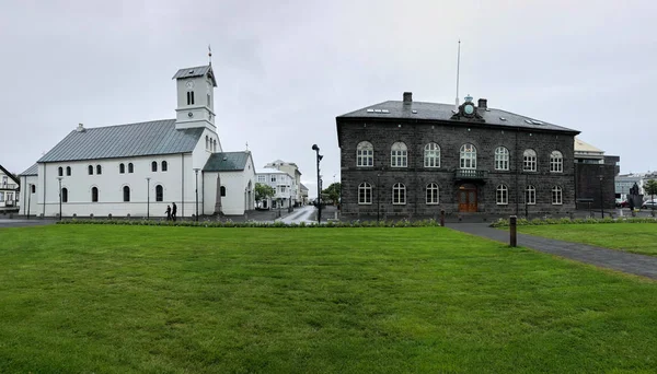 Reykjavik, Iceland - July 02, 2018: Domkirkjan - Reykjavik Lutheran Cathedral and Parliament (Althingi) House of Iceland. — 图库照片