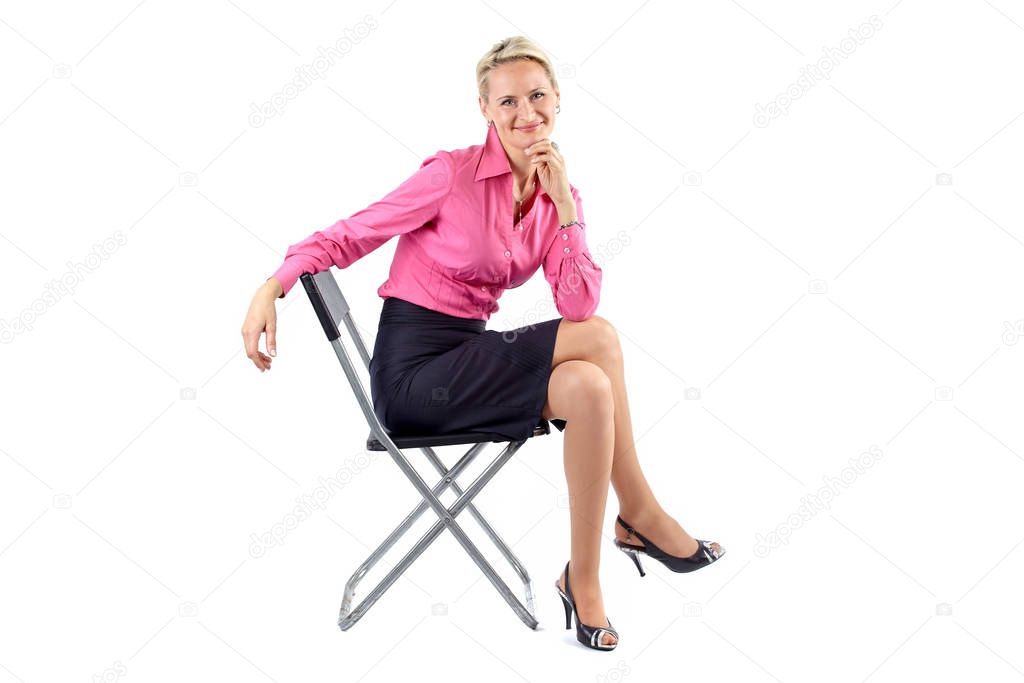 Successful smiling business woman sitting on a black chair on white background