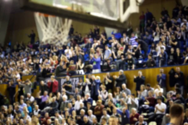 Fondo borroso de multitud de personas en una cancha de baloncesto — Foto de Stock