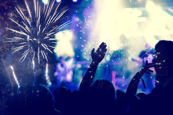 New Year concept - cheering crowd and fireworks — Stock Photo, Image