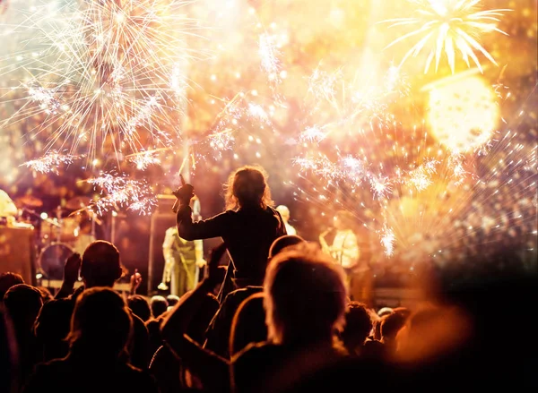 Cheering crowd watching fireworks - new year concept — Stock Photo, Image