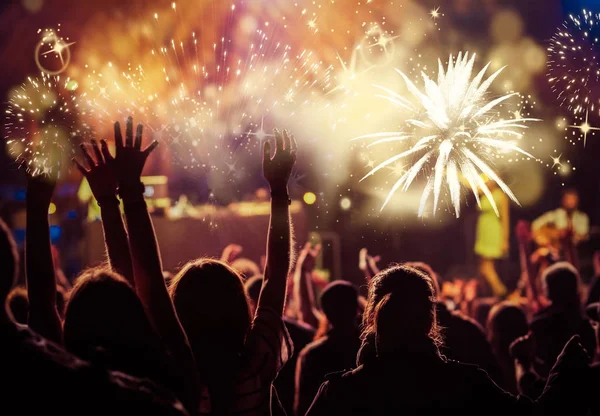 Cheering crowd watching fireworks - new year concept — Stock Photo, Image