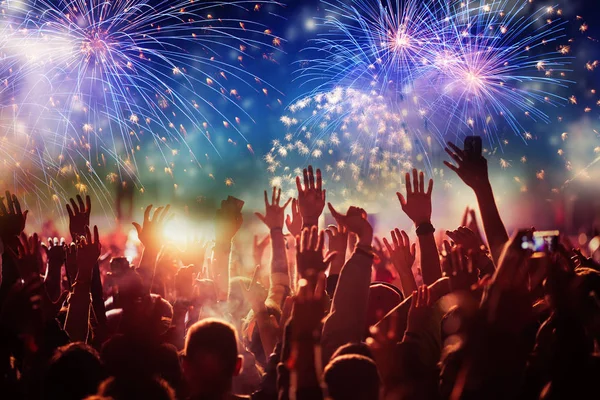 Cheering crowd watching fireworks - new year concept — Stock Photo, Image