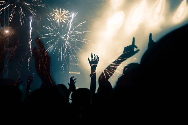 New Year concept - cheering crowd and fireworks — Stock Photo, Image