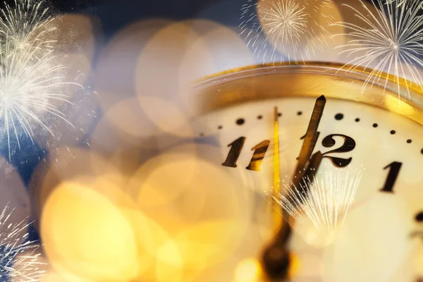 Old clock at twelve o'cklock on holiday fireworks background - N — Stock Photo, Image