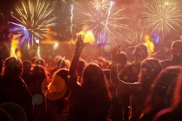 New Year concept - cheering crowd and fireworks — Stock Photo, Image