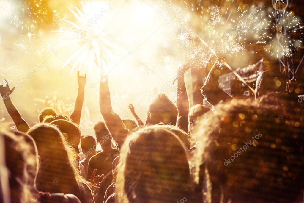 new Year concept - cheering crowd and fireworks