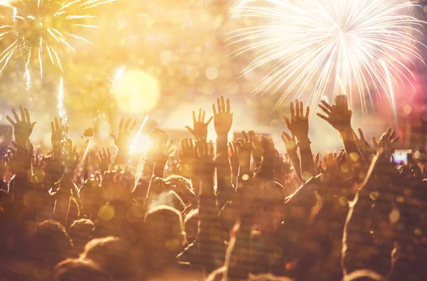 Cheering crowd watching fireworks - new year concept — Stock Photo, Image