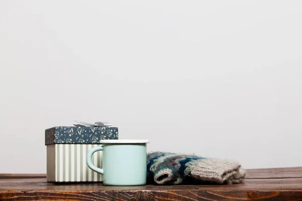 Taza verde brillante vintage con té caliente y guantes calientes en madera — Foto de Stock