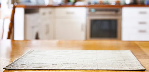 Blurred kitchen interior with napkin on table — Stock Photo, Image