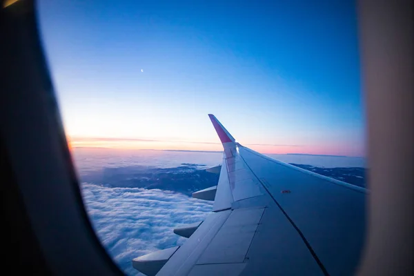 Plane flying over amazing sunrise over the clouds — Stock Photo, Image