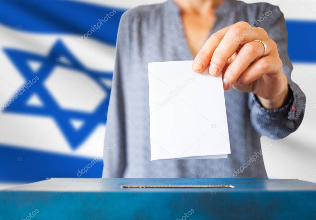 israel elections hand putting vote in ballot