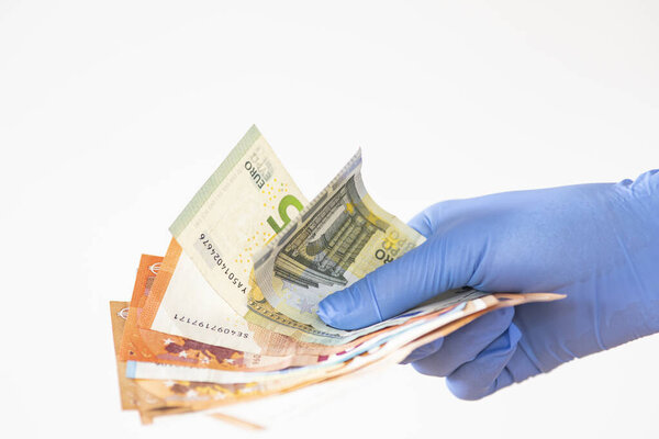 holding money with surgical gloves coronavirus protection