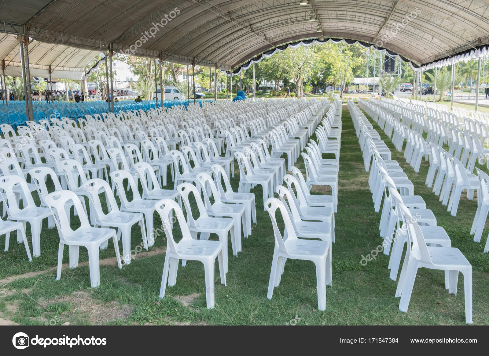 stack of white plastic chairs 171847384