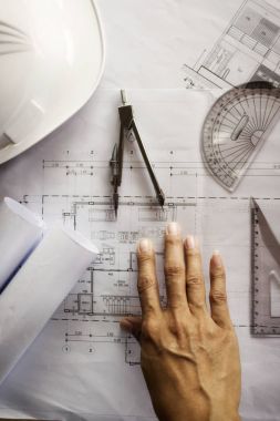 Hands of Engineer working on blueprint,Construction concept. Eng clipart