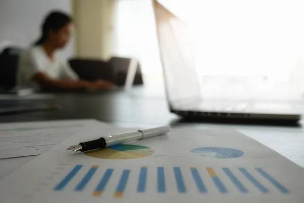 Business concept analyzing investment charts on desk.