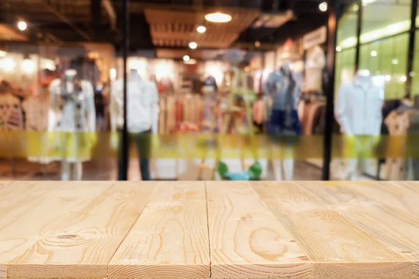 Plataforma de espaço de mesa de madeira vazia e shopping center borrado ou centro comercial para montagem de exibição de produto . — Fotografia de Stock