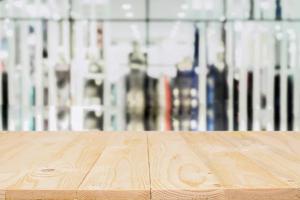 Empty wooden table space platform and blurred shopping mall or shopping center background for product display montage.