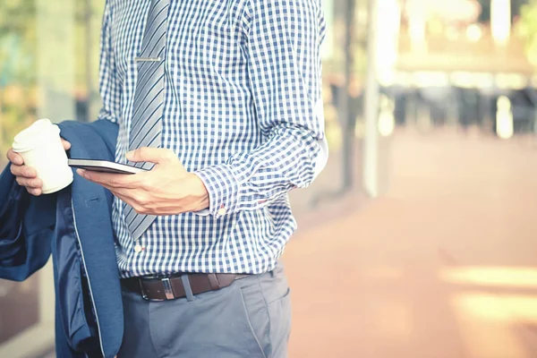 Handsome Young Businessman Holding His Laptop While Using His Phone — Stock Photo, Image