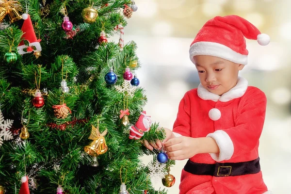 Merry Christmas.Cute little child is decorating the Christmas tr Royalty Free Stock Images