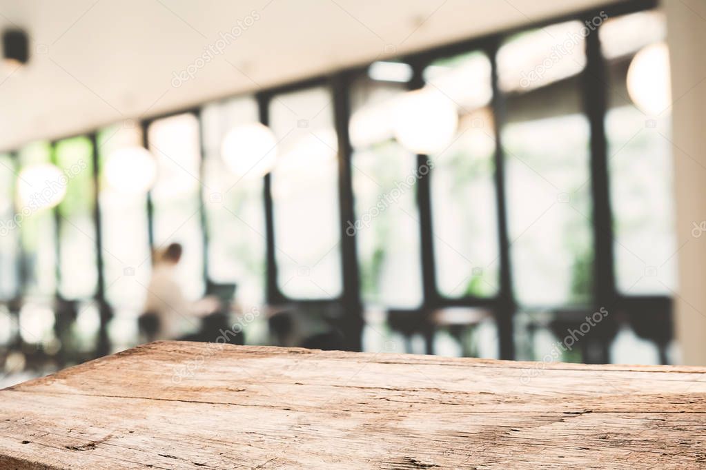 Empty wooden table space platform and blurred coffee shop where 