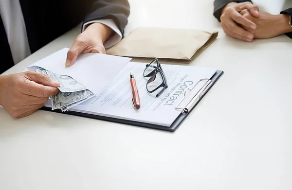 Businessman in suit hides money. A bribe in the form of dollar b — Stock Photo, Image