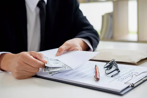 Businessman in suit hides money. A bribe in the form of dollar b — Stock Photo, Image