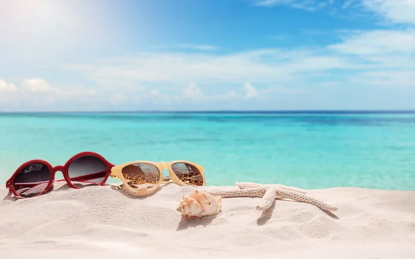 Summer vacation concept with accessories on sandy beach — Stock Photo, Image