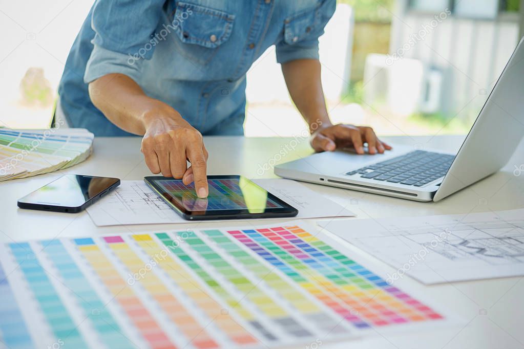 Graphic design and color swatches and pens on a desk. Architectu