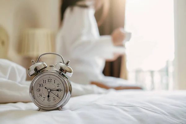 Alarm clock standing on bedside table has already rung early mor — Stock Photo, Image