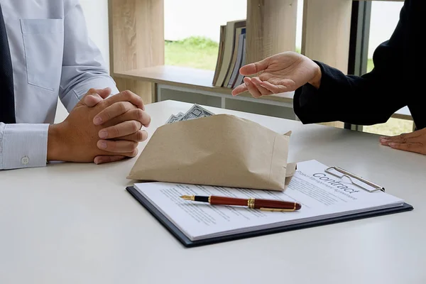 Businessman in suit hides money. A bribe in the form of dollar b — Stock Photo, Image