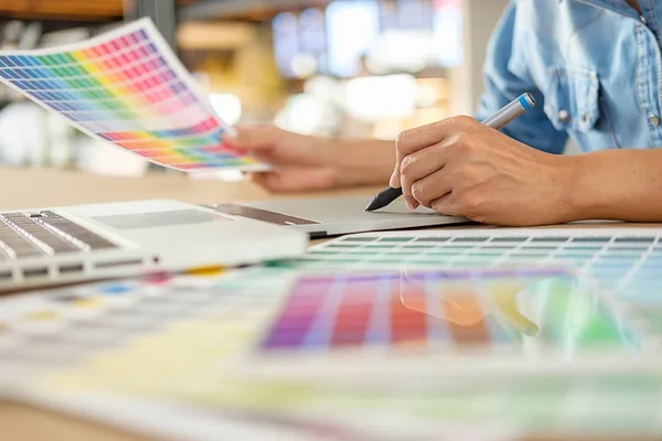 Graphic design and color swatches and pens on a desk. Architectu