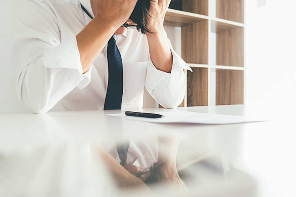 Sad dismissed businessman sitting outside the office after losing his job